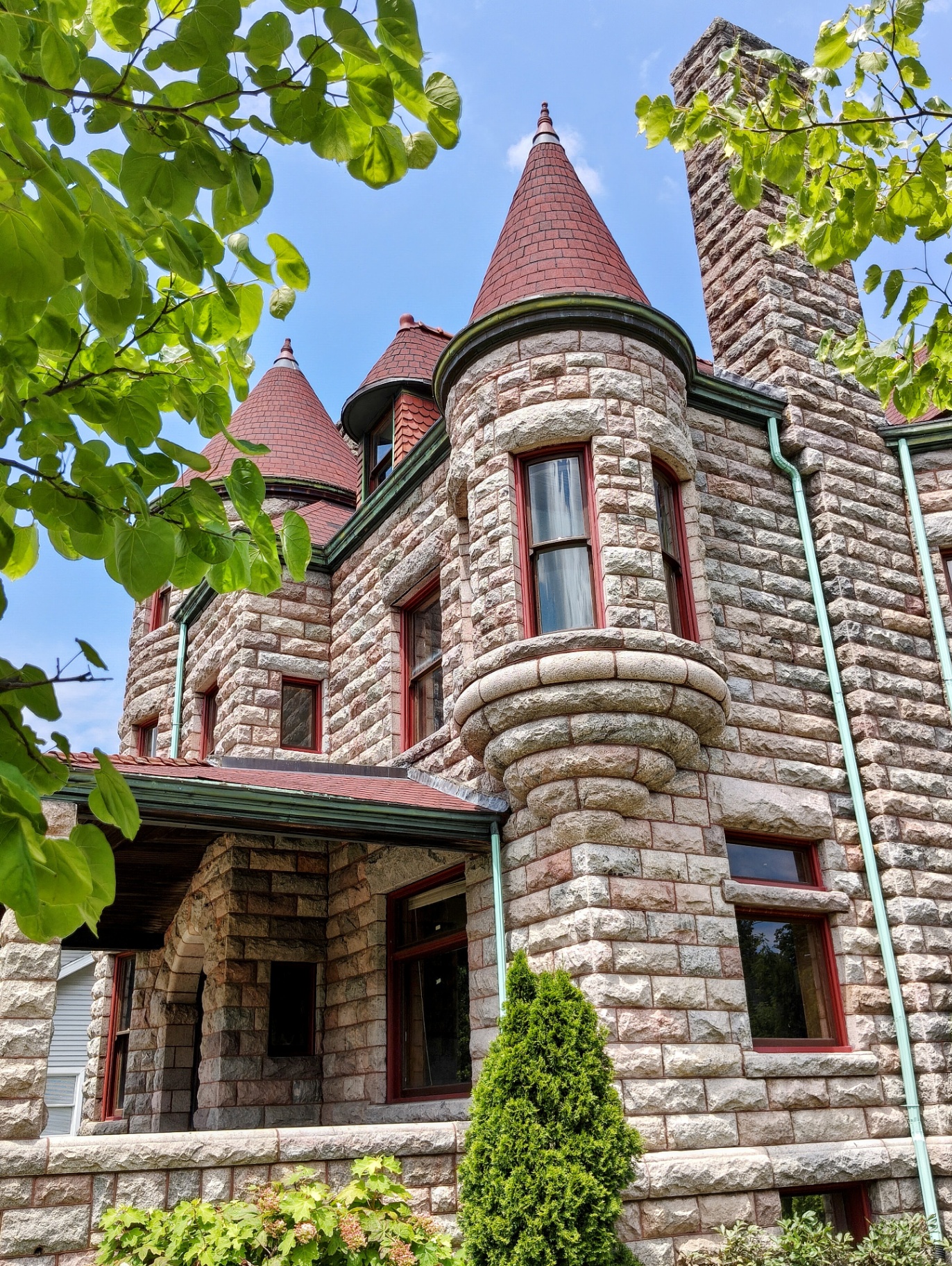 Castle turrets framed by spring foliage