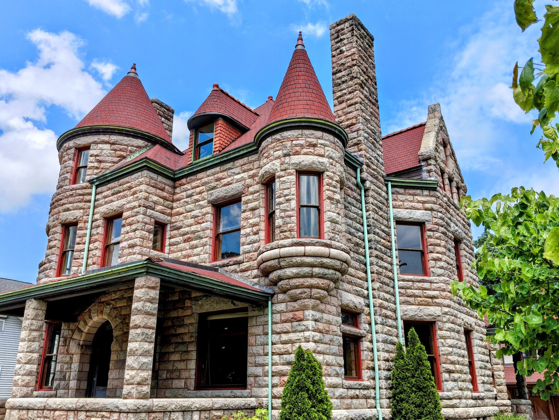 The Castle of South Bend — a Romanesque Revival stone mansion with red-tile turrets
