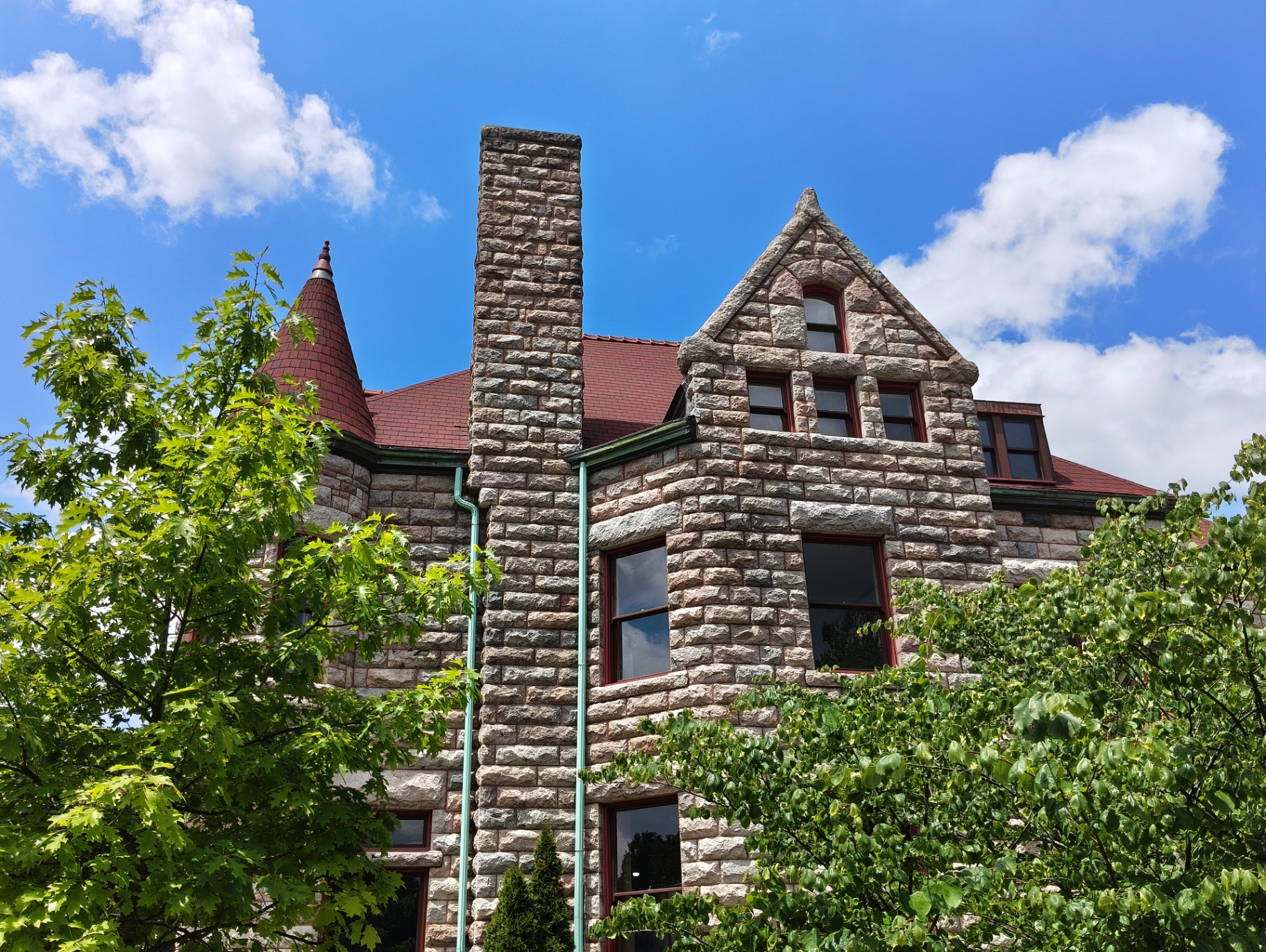 Stone gable and chimney of the Castle against a bright sky